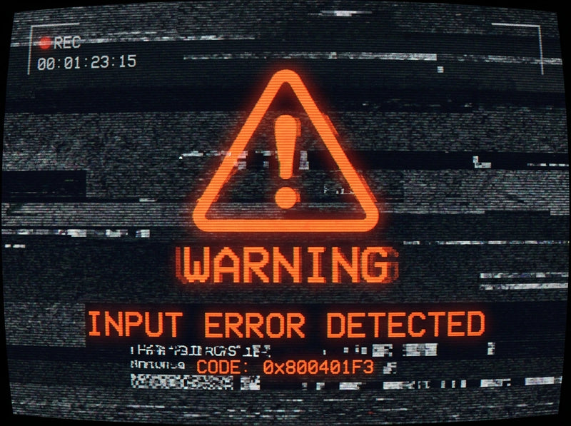 Digital warning screen with a red exclamation mark and 'WARNING: Input Error Detected' text on a black background with digital noise.