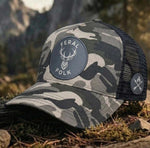 Camouflage Feral Folk cap with a logo on a natural background