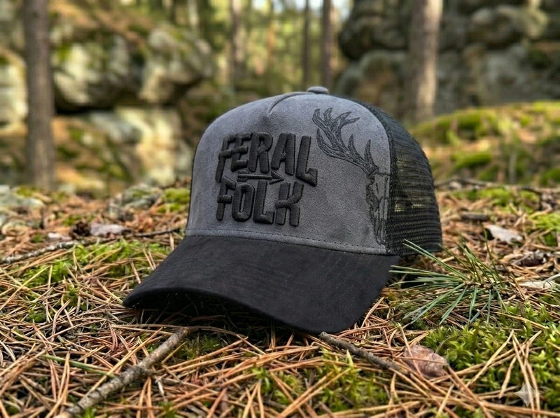 Gray and black cap with 'Feral Folk' text on a forest floor background