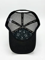 Black cap with mesh back and deer pattern on a white background
